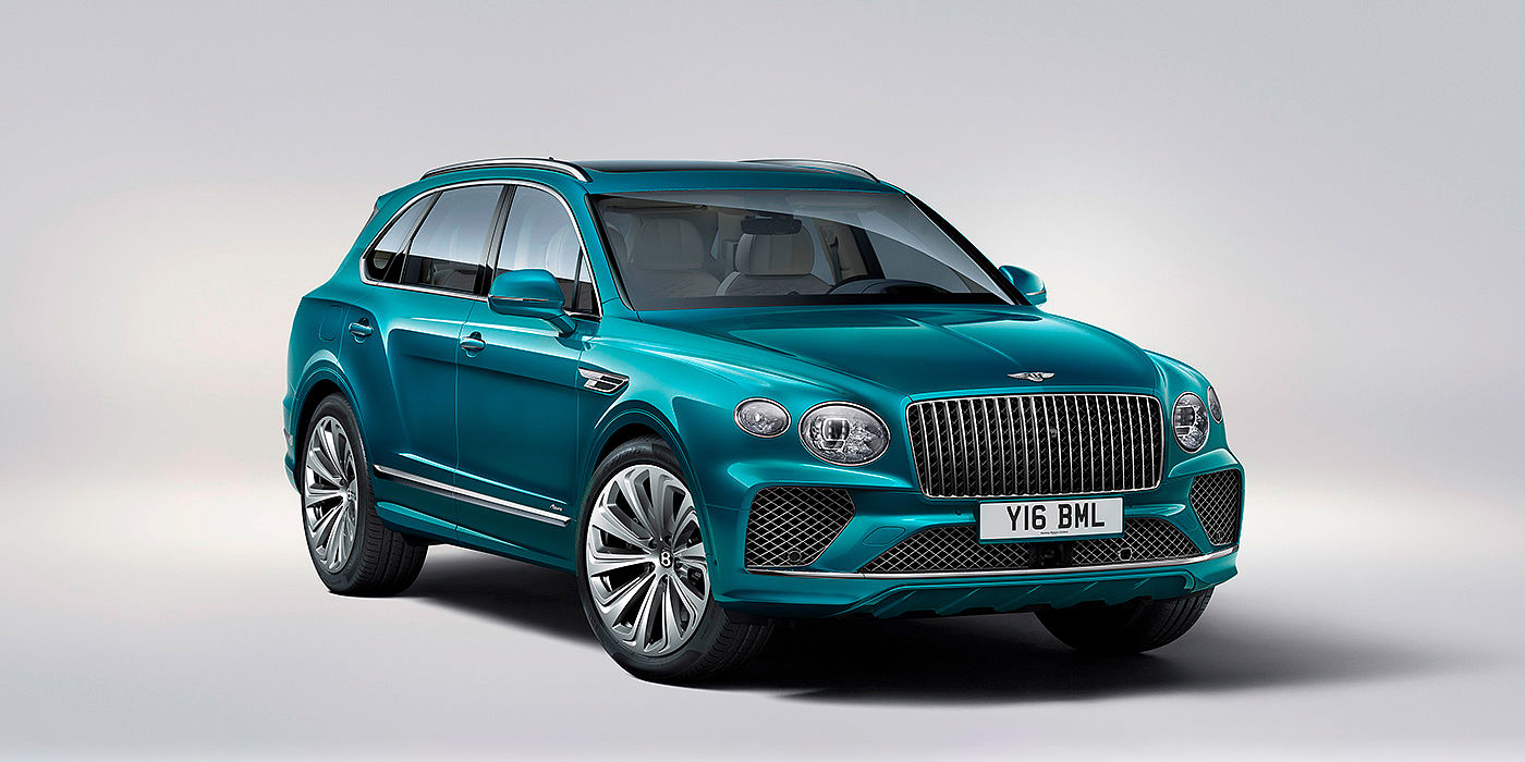 Bentley Riga Bentley Bentayga Azure front three-quarter view, featuring a fluted chrome grille with a matrix lower grille and chrome accents in Topaz blue paint.