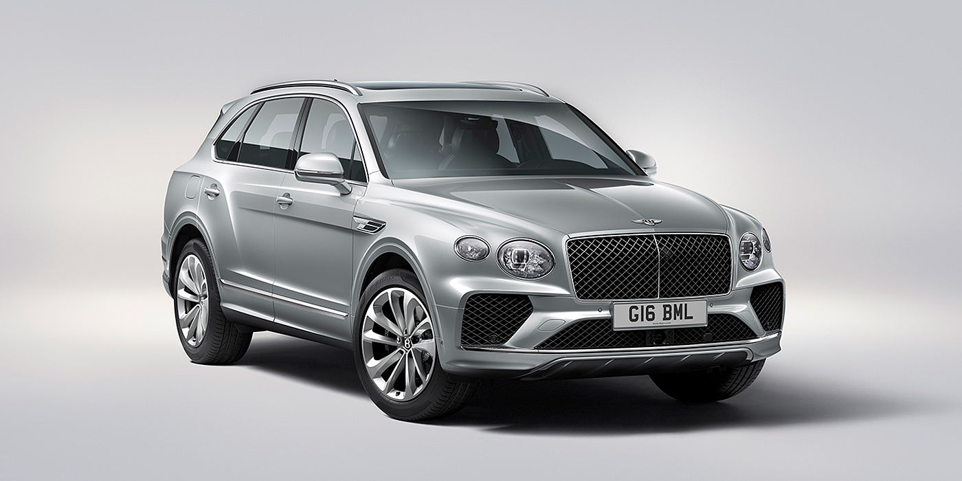Bentley Riga Bentley Bentayga in Moonbeam paint, front three-quarter view, featuring a matrix grille and elliptical LED headlights.