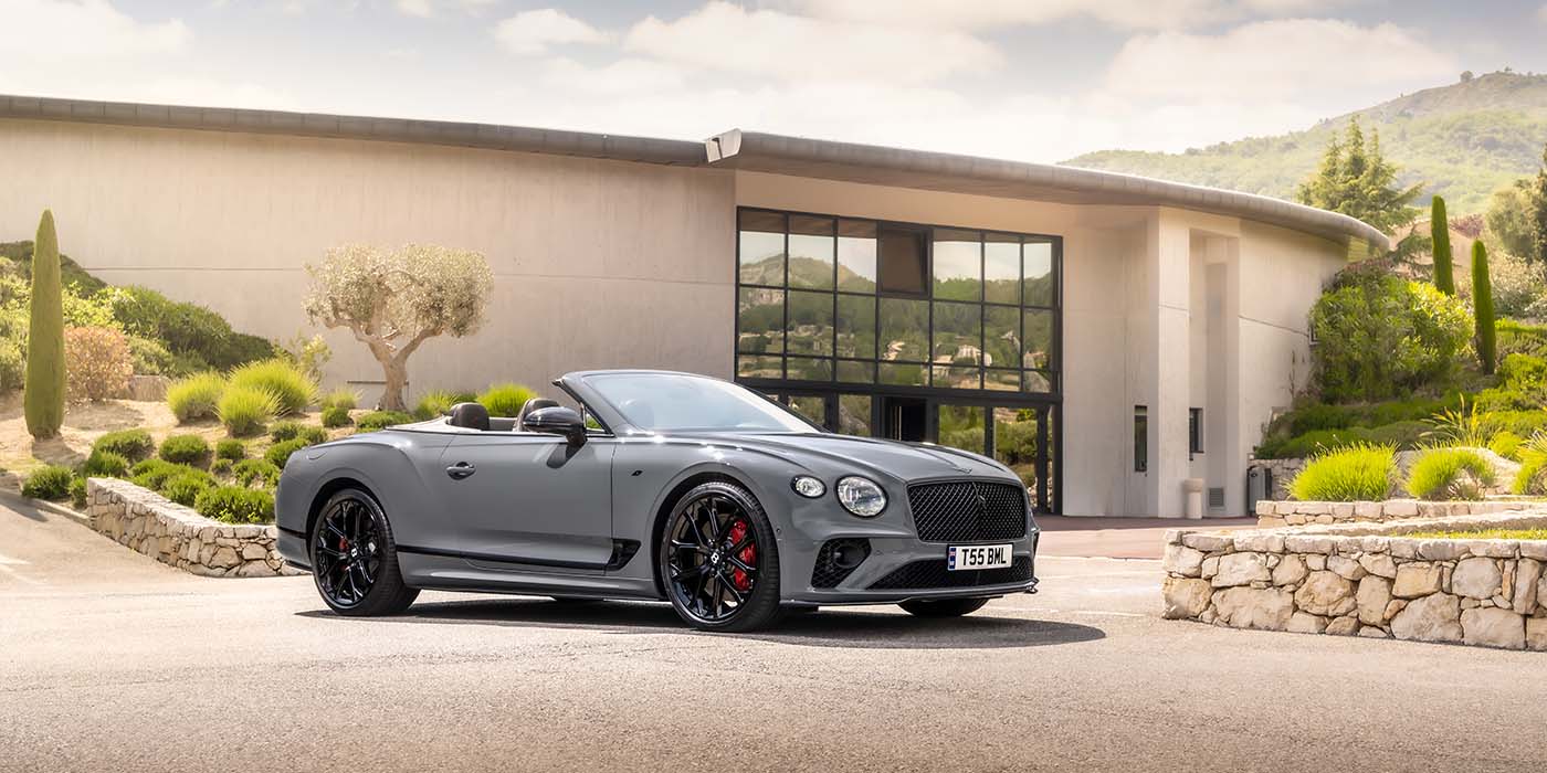 Bentley Riga Bentley Continental GTC S convertible in Cambrian Grey paint front 34 static near house