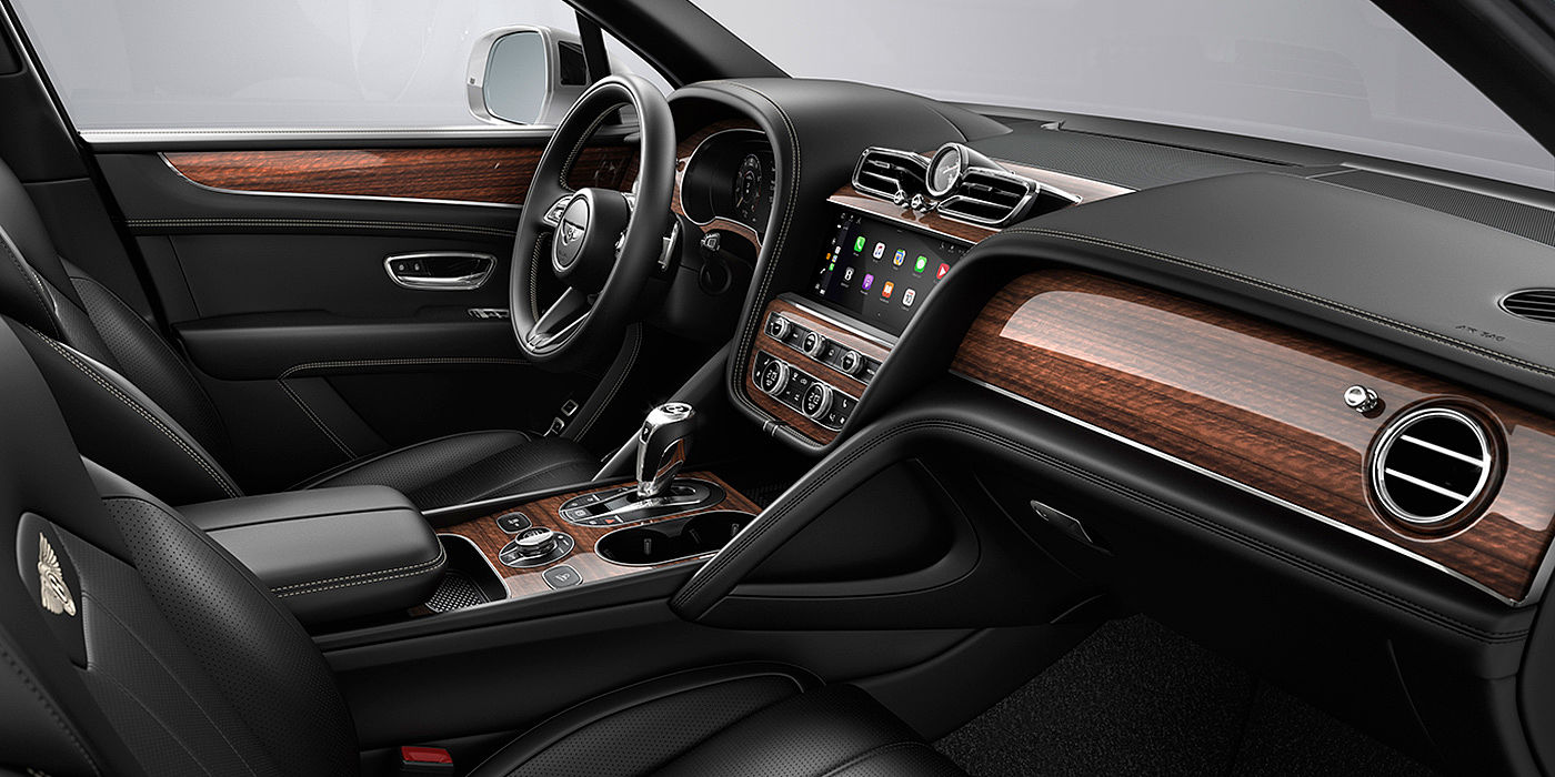 Bentley Riga Bentley Bentayga interior with a Crown Cut Walnut veneer, view from the passenger seat over looking the driver's seat.