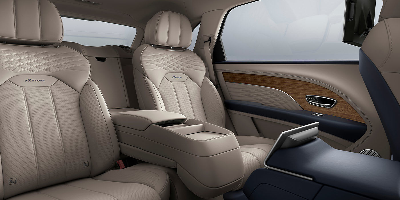 Bentley Riga Bentley Bentayga EWB Azure interior view for rear passengers with Portland hide featuring Azure Emblem in Imperial Blue contrast stitch.