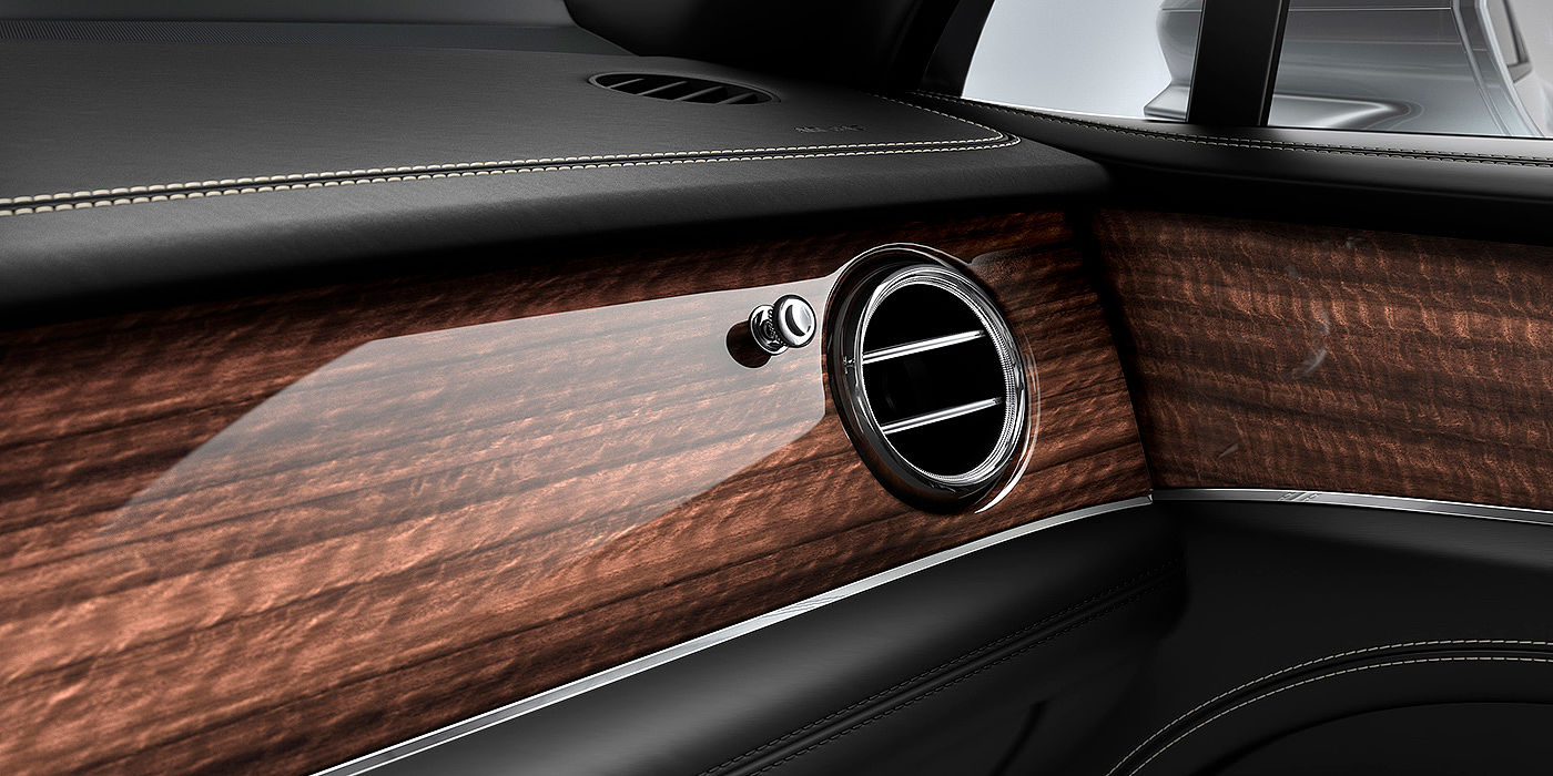 Bentley Riga Bentley Bentayga front interior Crown Cut Walnut veneer and chrome air vent.