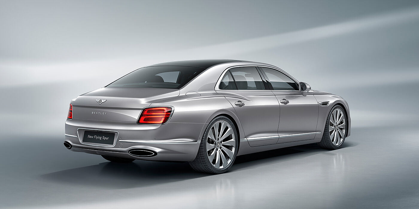Bentley Riga New Bentley Flying Spur sedan rear view in Silverlake paint with ten spoke wheels and chrome matrix grille