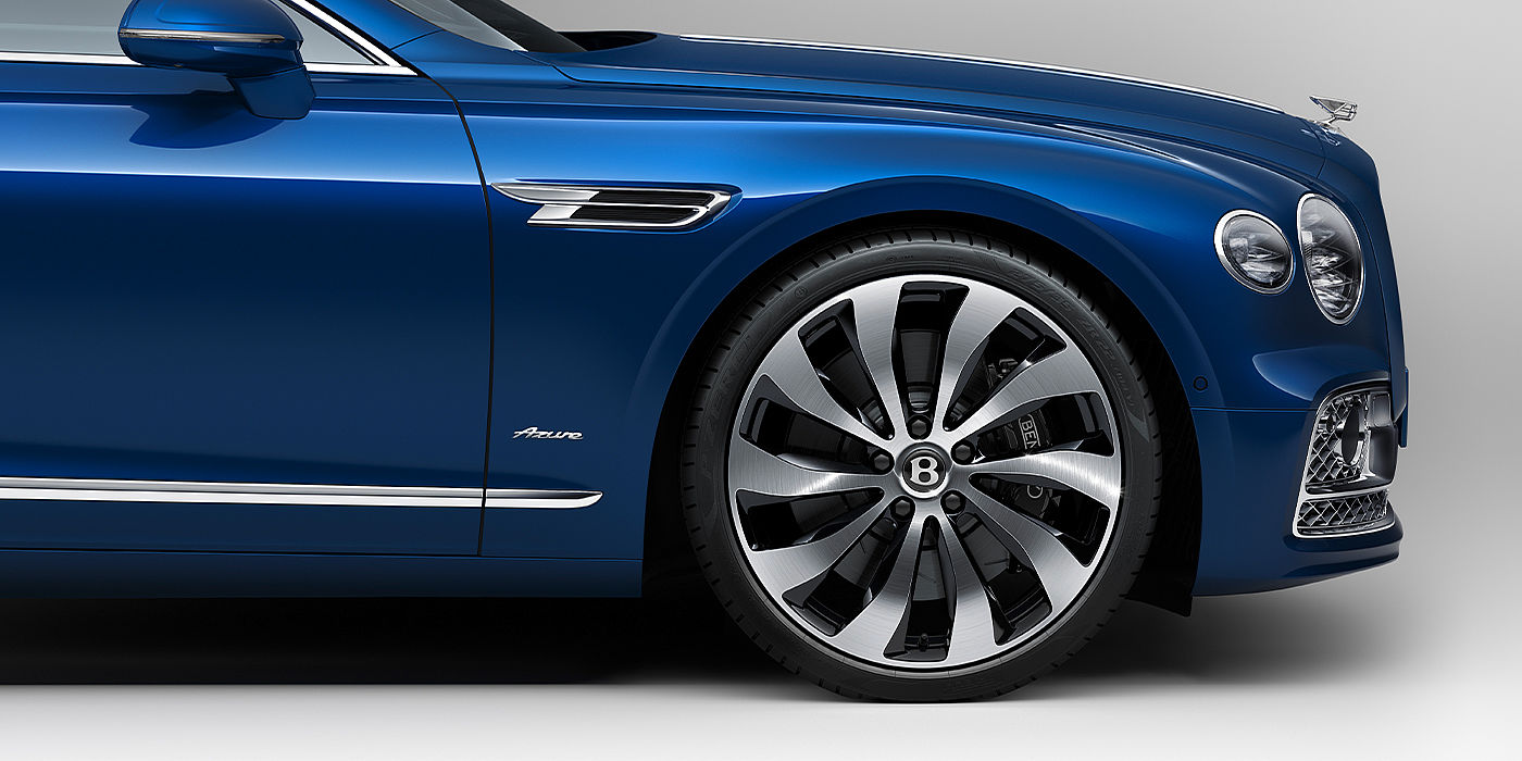 Bentley Riga Bentley Flying Spur Azure sedan side close up in Sequin Blue paint with Azure badge