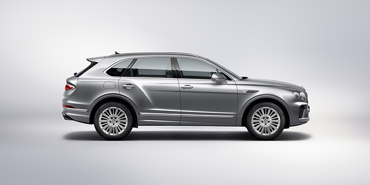 Bentley Riga Bentley Bentayga SUV side profile in Moonbeam silver paint against white background featuring 21 inch 5 spoke wheels